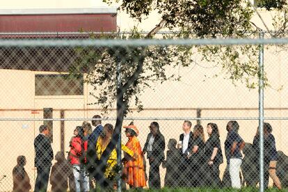 Nine members of Congress wait to enter Marjory Stoneman Douglas High School, Friday, Aug. 4, 2023, in Parkland, Fla