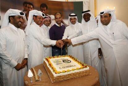 Pep Guardiola (c) on a trip to Qatar to promote its bid to host the World Cup.
