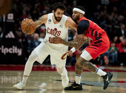 Cleveland Cavaliers guard Ricky Rubio, left, dribbles around Portland Trail Blazers guard Gary Payton II during the first half of an NBA basketball game in Portland, Ore., Thursday, Jan. 12, 2023.