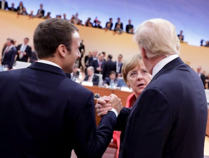 La canciller alemana Angela Merkel habla a Donald Trump y a Emmanuel Macron durante el inicio de la primera sesión del G20.