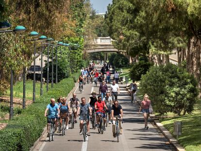 Ciclistas y paseantes en el carril bici del Jardín del Turia de Valencia.