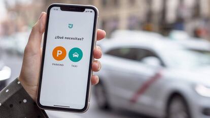 Una persona utiliza la aplicación de Joinup, que ahora incluye parkings además de taxis.