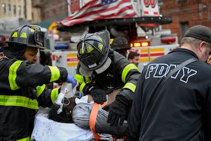 Trabajadores de emergencias trasladan a un herido. 