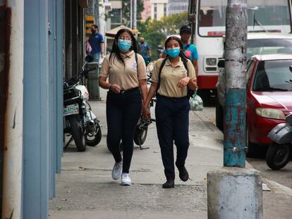 Dos estudiantes caminan por las calles de Caracas.