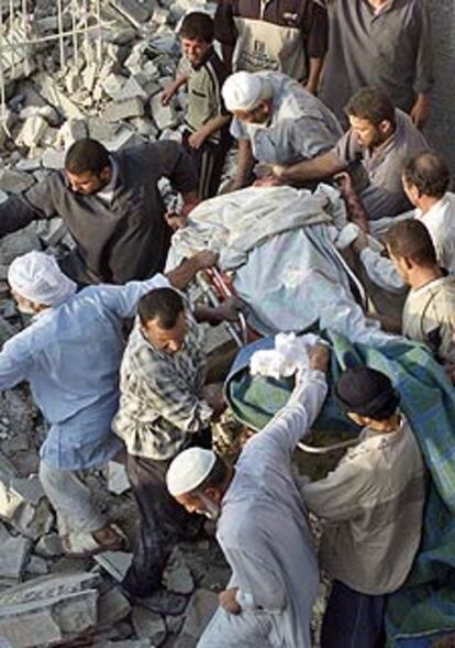 Varios hombres portan un cuerpo tras los bombardeos en Faluya.