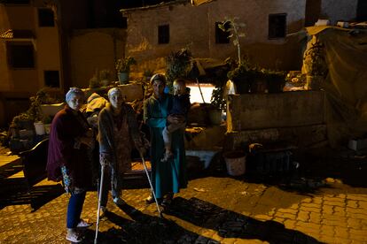 Rachida Aitzagut and her sisters-in-law pose in front of their collapsed house. 