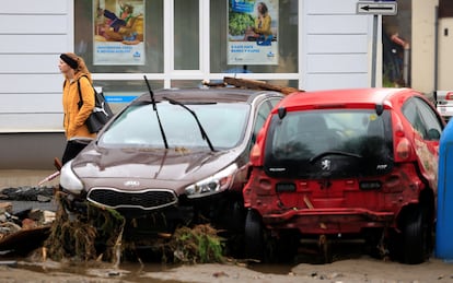 Una mujer camina junto a varios coches dañados tras las  inundaciones en Jesenik (República checa), este lunes. 