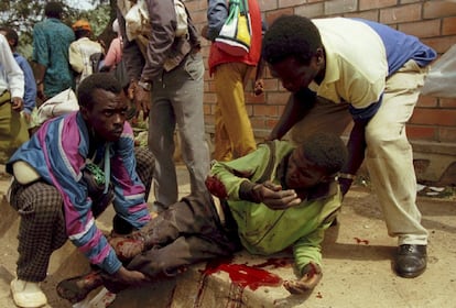 El mayor genocidio registrado en el mundo, según la ONU, comenzó la noche del 6 de abril de 1994, horas después de que el presidente del país, Juvenal Habyarimana, muriera tras ser alcanzado por dos misiles el avión en el que se disponía a aterrizar en el aeropuerto de Kigali. En la imagen, varias personas ayudan a levantarse a un herido por los disparos de los miembros del Frente Patriótico de Ruanda en un campamento de Kigali, el 1 de julio de 1994.