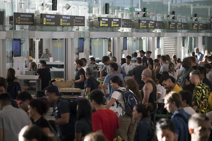 Pasajeros esperan en fila para pasar por los controles de seguridad en el Aeropuerto de El Prat, en Barcelona (España), el 9 de agosto de 2019. La plantilla de Trablisa decidió el jueves por amplia mayoría, con 175 votos a favor y solo dos en contra, ir a huelga indefinida para exigir mejoras salariales y laborales, tras fracasar las reuniones de mediación entre empresa y sindicatos. La Delegación del Gobierno en Cataluña ha decretado unos servicios mínimos del 90 % por esta huelga, aunque el comité advirtió de que difícilmente se podrían cumplir.