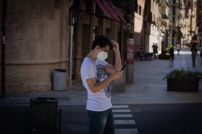 Un joven camina en el centro de Lleida (Segrià) un día después del anunció del confinamiento de la comarca tras rebrotes de covid-19