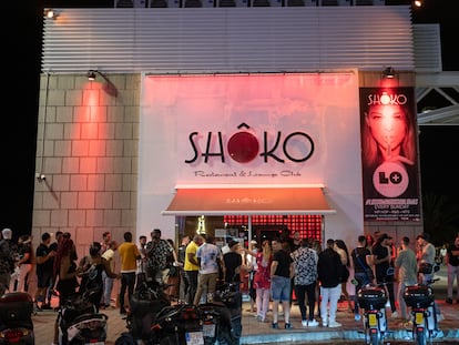 People wait in line outside a nightclub in Barcelona on June 27.