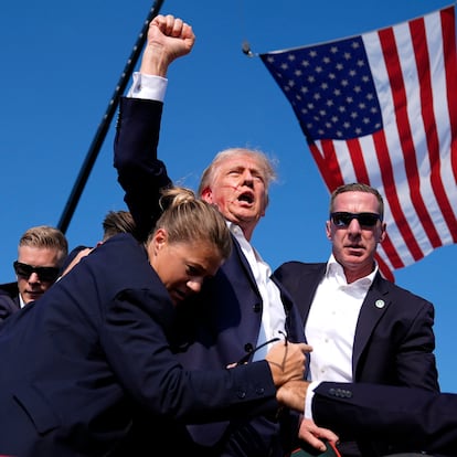 FILE - Republican presidential candidate former President Donald Trump is surrounded by U.S. Secret Service agents after an assassination attempt at a campaign rally in Butler, Pa., July 13, 2024. (AP Photo/Evan Vucci, File)