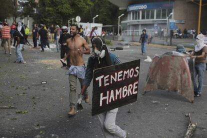 "We're hungry" reads a placard carried by a protester Monday in Caracas.