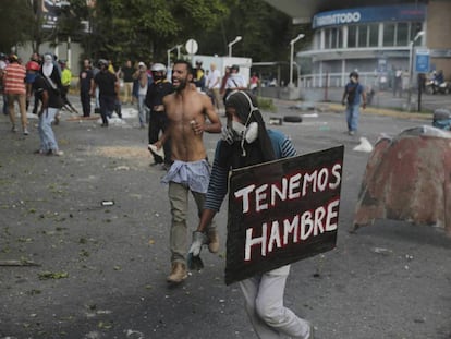 "We're hungry" reads a placard carried by a protester Monday in Caracas.