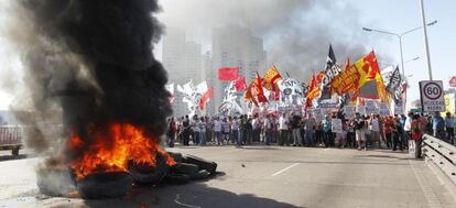 Un piquete quema neumáticos y corta el puente Pueyrredon, este martes en Buenos Aires, en la jornada de huelga general