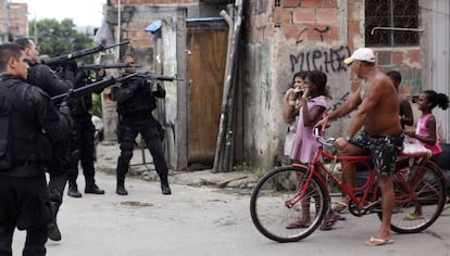 Police enter a poor Rio neighborhood in March 2014.