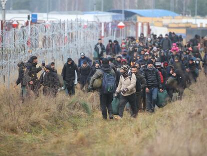 Un grupo de migrantes camina a lo largo de la frontera de Bielorrusia para intentar entrar en Polonia, en noviembre de 2021.