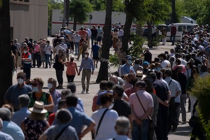 People wait in line to be vaccinated at the Estadio Olímpico in Seville on May 20.