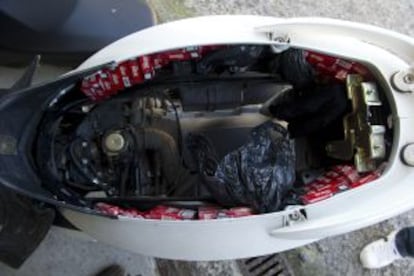 A scooter loaded with cigarette packets.