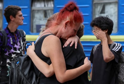 A woman hugs her relatives before boarding an evacuation train to western Ukraine, in Pokrovsk on Friday.