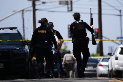 Armed people at the scene of the shooting that occurred in front of the Islamic Center of San Diego