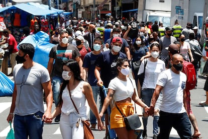 Dezenas de pessoas caminham no centro de São Paulo no dia 18 de dezembro.