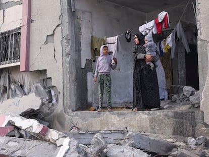 Una mujer palestina con sus hijos, en una casa dañada por los bombardeos israelíes, este martes en Rafah.