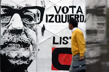 Un ciudadano camina en Santiago junto a un cartel en el que se recuerda a Salvador Allende.