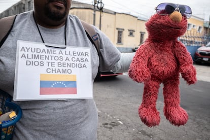Guatemala'da siyasi sığınma talebinde bulunan Venezuelalı göçmen Pablo, 4 Temmuz'da ailesine destek olmak için tarihi merkezin sokaklarında birlikte çalıştığı Elmo kuklasını sergiliyor.