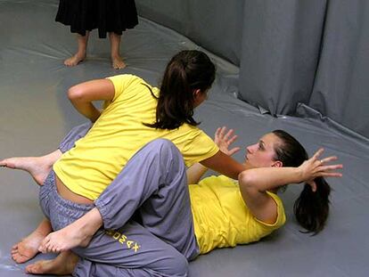 Dos instructoras practican ejercicios de autodefensa en una demostración.