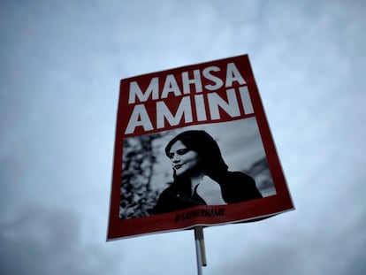 FILE - A woman holds a placard with a picture of Iranian Mahsa Amini as she attends a protest against her death, in Berlin, Germany, Wednesday, Sept. 28, 2022. Nasreen Shakarami, the mother of Amini, said Friday, Oct. 7, the teen was killed by repeated blows to the head as part of Iran's crackdown on anti-hijab protests roiling the country. Shakarami also said authorities kept her daughter Nika’s death a secret for nine days and then snatched the body from a morgue to bury her in a remote area, against the family’s wishes. (AP Photo/Markus Schreiber)