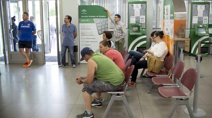 Varias personas esperan su turno en la oficina de empleo de la localidad de Dos Hermanas, Sevilla.