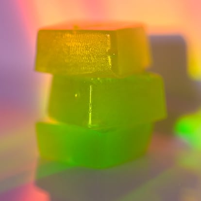 Stack of edible cannabis gummies in rainbow light