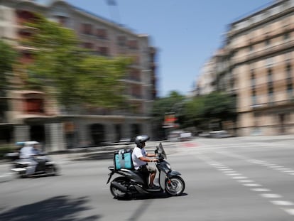 Un repartidor de Deliveroo durante una entrega de un pedido, en 2019 en Barcelona.