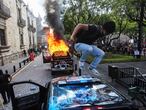 A demonstrator jumps on a damaged police vehicle after demonstrators set it on fire during a protest to demand justice for Giovanni Lopez, a construction worker who died after being arrested for not wearing a face mask in public, during the coronavirus disease (COVID-19) outbreak in Guadalajara, Mexico June 4, 2020. REUTERS/Fernando Carranza