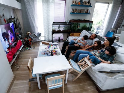 Una familia mira la televisión en casa durante el confinamiento, en Madrid.