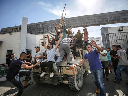 A group of Palestinians on an Israeli military vehicle in Gaza City on October 7, 2023.