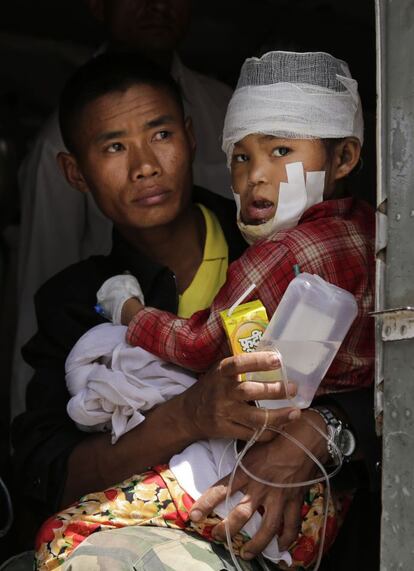 Niño herido en el terremoro del sábado en Nepal llevado por un soldado.