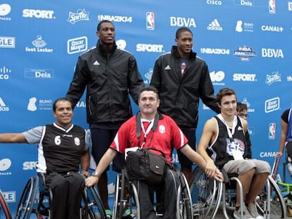 Thaddeus Young, izquierda, y Rodney Williams (d) junto a jugadores de baloncesto en sillas de ruedas en Bilbao.