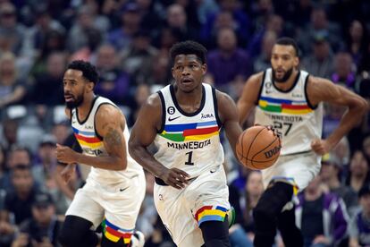 Minnesota Timberwolves guard Anthony Edwards (1) starts a fast break, trailed by teammates, guard Mike Conley (10) and center Rudy Gobert (27) in the first quarter of an NBA basketball game against the Sacramento Kings in Sacramento, Calif., Monday, March 27, 2023.