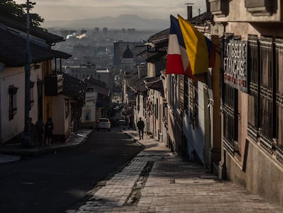 A lone pedestrian walks down a steep street in Bogotá, Colombia; May 3, 2022.