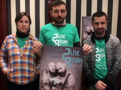 El director de Zinegoak, Pau Guillén, sostiene el cartel del festival flanqueado por los miembros de la organización Karmele Merini y Javier Regalado.