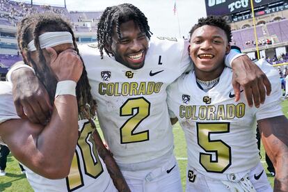 Colorado quarterback Shedeur Sanders (2) embraces wide receivers Xavier Weaver (10) and Jimmy Horn Jr. (5) after an NCAA college football game Saturday, Sept. 2, 2023, in Fort Worth, Texas.