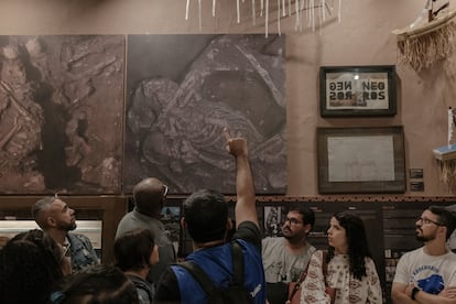 A tour guide explains an exhibit at the IPN museum in Rio de Janeiro