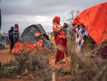 A Somali woman breastfeeds her child at a camp for displaced people on the outskirts of Dollow, Somalia in September 2022.