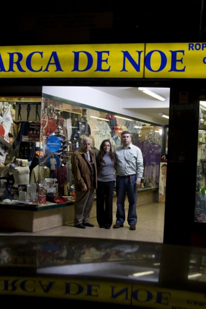 José Luis Cortés, 78, and his children in the doorway of his business.