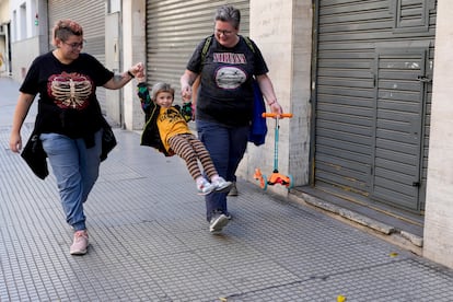 Anastasia Domini, left, and her wife Anna, swing their daughter Una as they walk to a park in Buenos Aires, Argentina, on April 22, 2023.