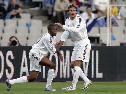 Beckham ayuda a levantarse a Robinho.