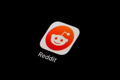 The Reddit app icon is seen on a smartphone