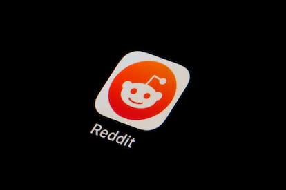 The Reddit app icon is seen on a smartphone